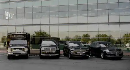 Four fleet cars in front of a glass building